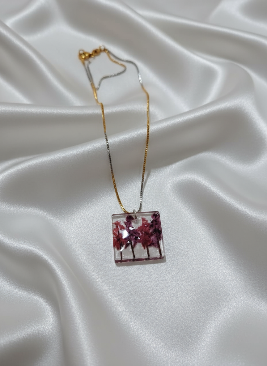 Abstract resin necklace on off-white satin cloth