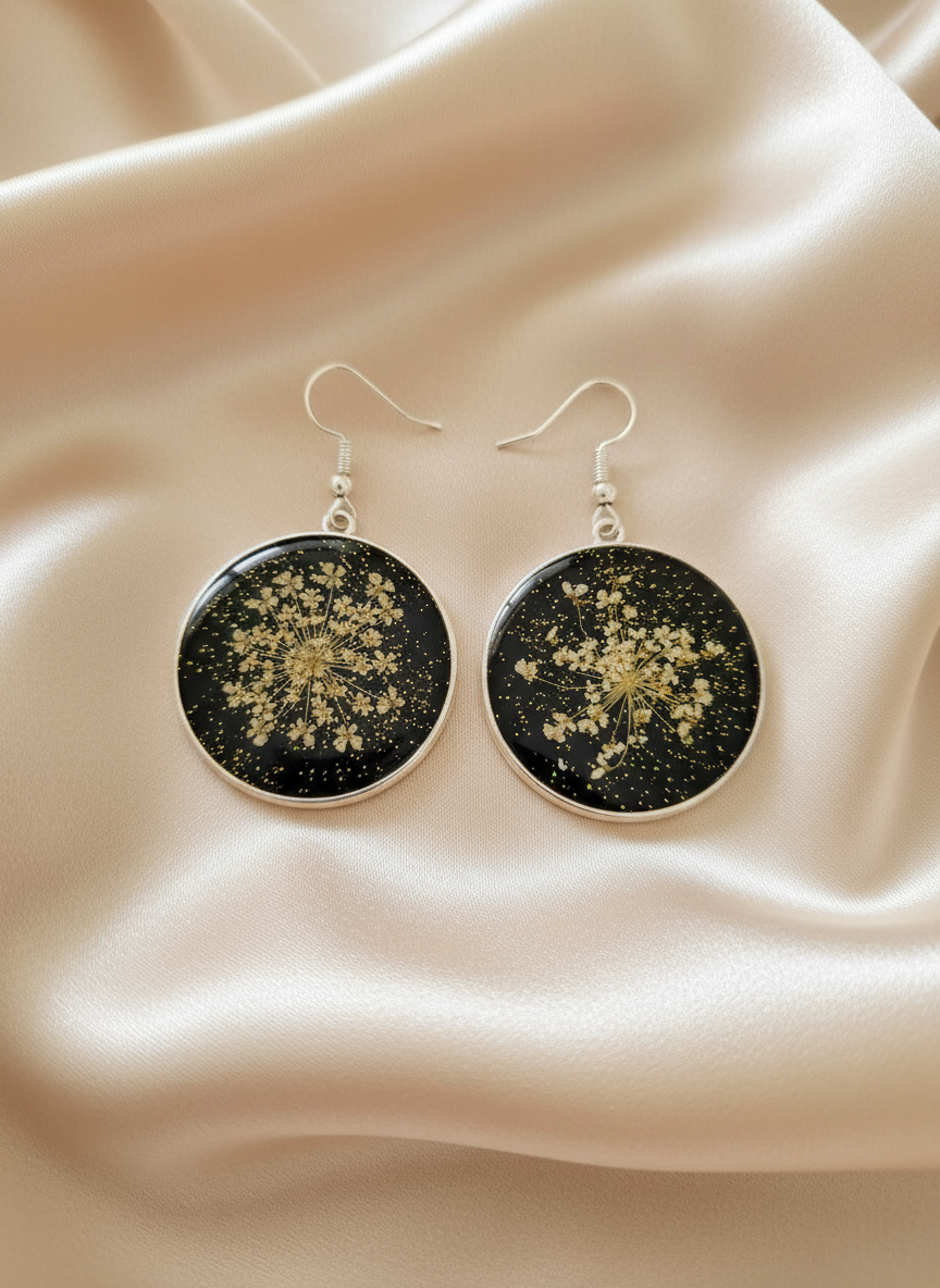 Circular pressed flower earrings on satin cloth
