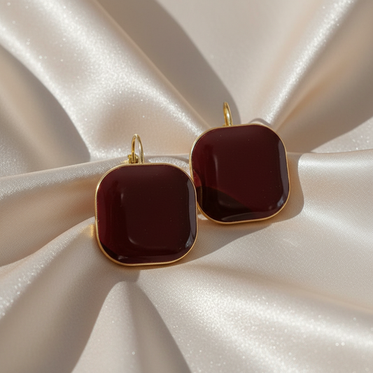 Elegant earrings displayed on light satin cloth with luxury styling