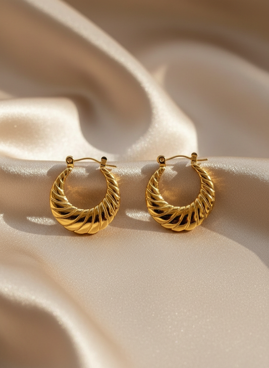 Gold Twisted Hoop Earrings on Beige Satin