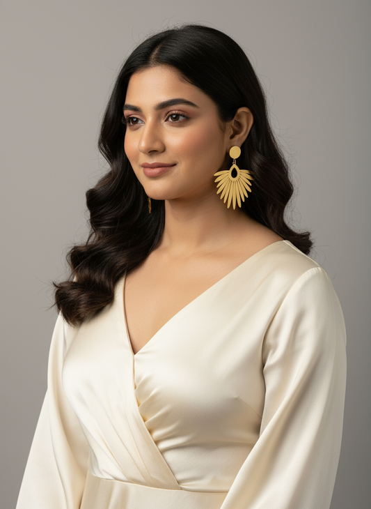 Indian model wearing gold feather earrings