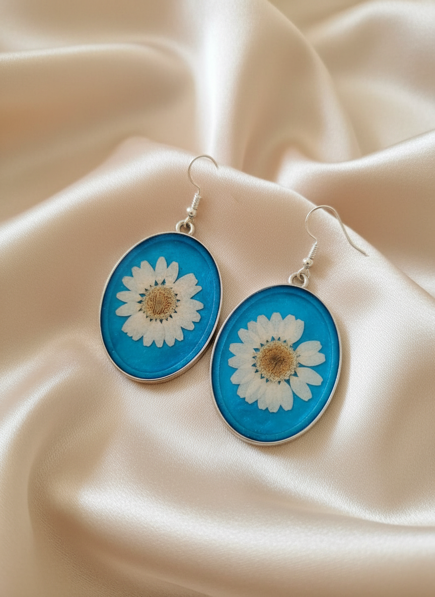 Oval daisy earrings on satin cloth