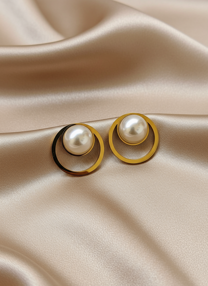 Pearl circle earrings on light coffee satin cloth