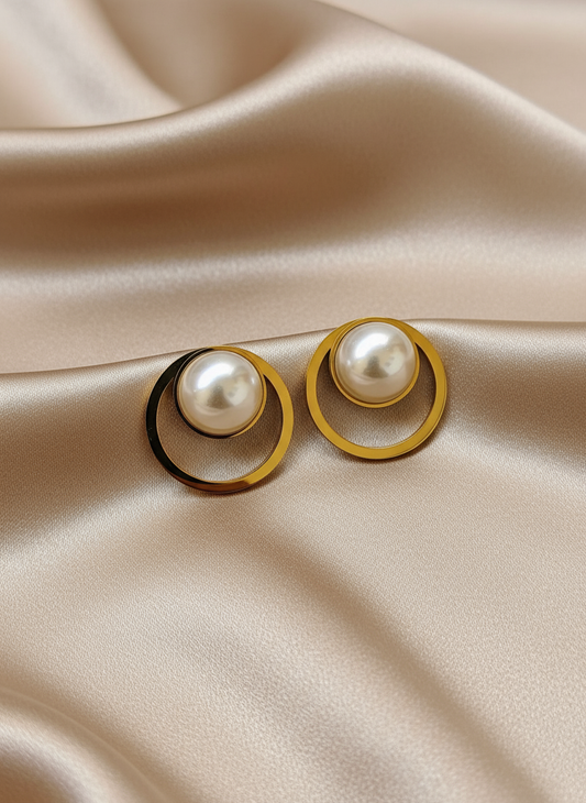 Pearl circle earrings on light coffee satin cloth