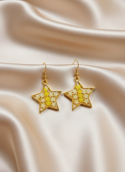 Star-shaped resin earrings on satin cloth