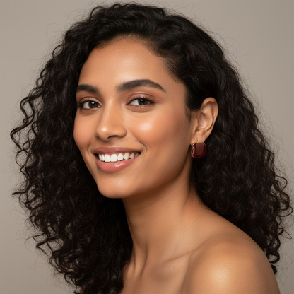 Young Indian model with curly hair wearing smaller earrings in jewelry photography